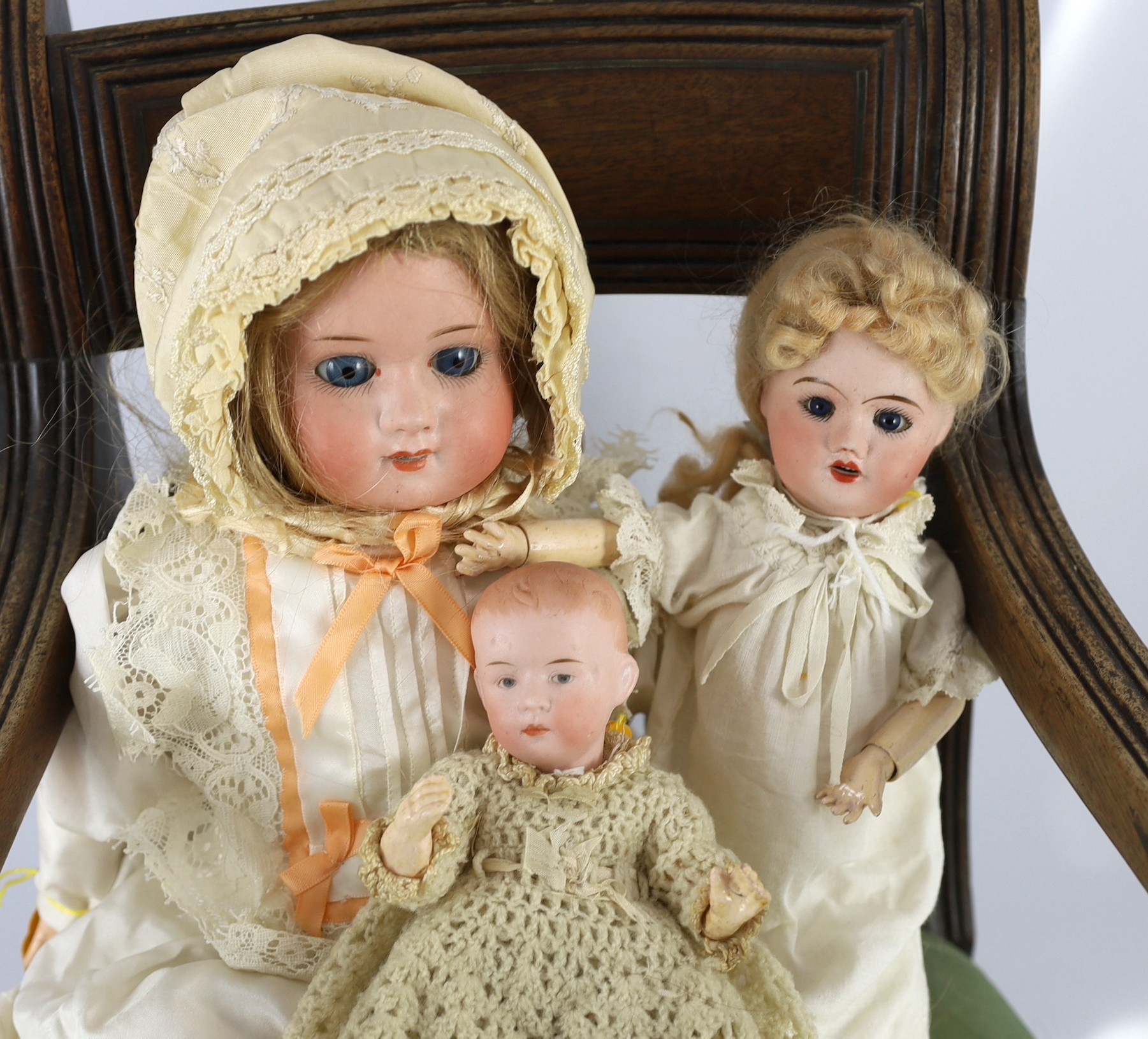 A Max Oscar Arnold bisque doll, German, circa 1920, 11.5in. (3) Please note the chair is for display purposes only.